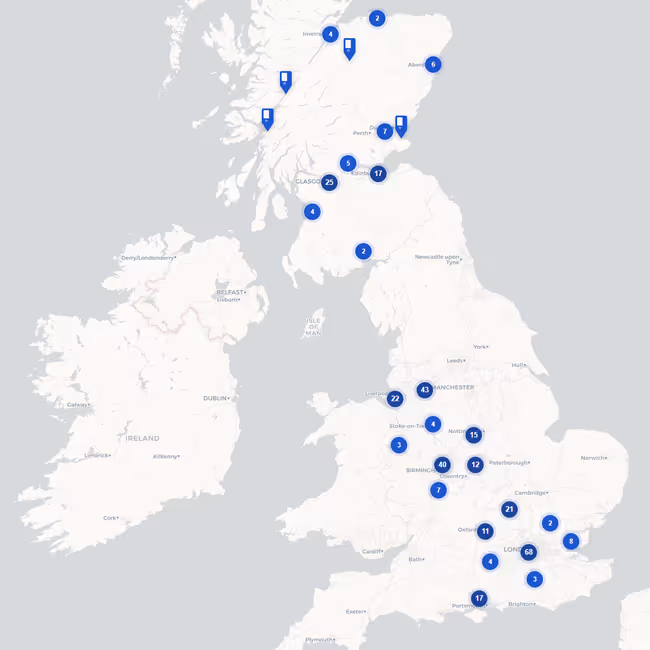 Map of the United Kingdom with blue markers showing clustered locations of Premier Inn hotels across major cities.