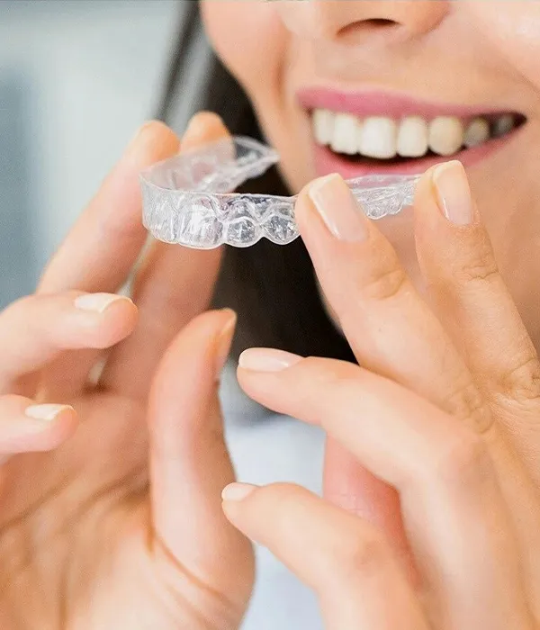 Woman trying on Spark clear aligners