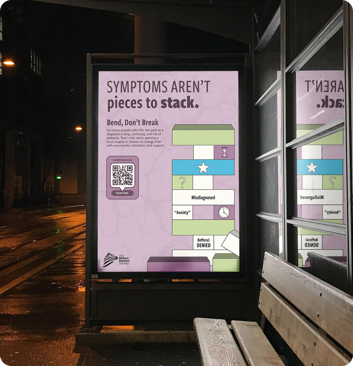 Bus stop poster about Ehlers-Danlos syndrome with headline 'Symptoms Aren’t pieces to stack', a Jenga block illustration, QR code, and text promoting local support in Ottawa.