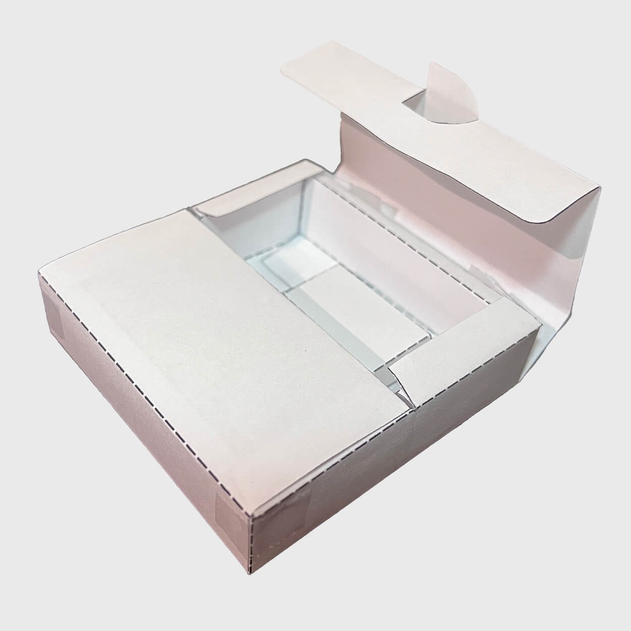 Open white paper box with a tuck flap lid on a light grey background.