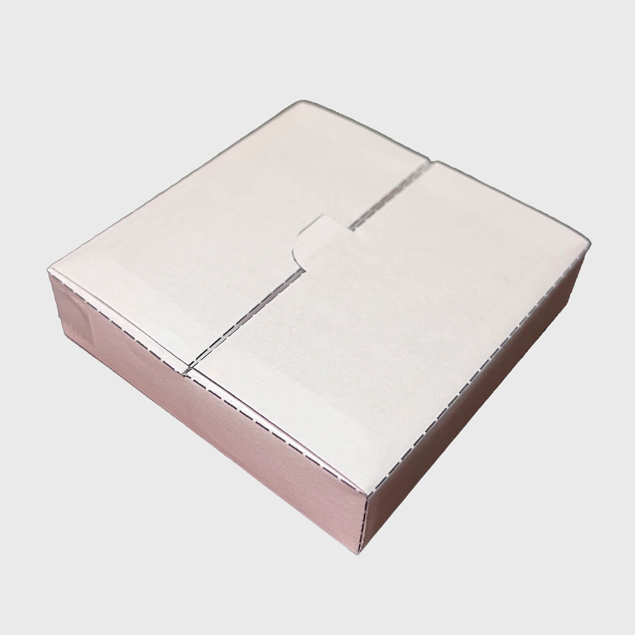 Closed square white paper box with a tuck-in flap lid on a light grey background.