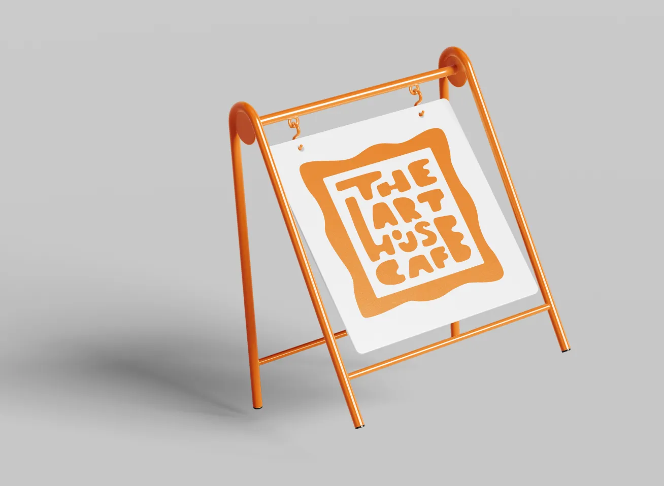 Orange metal A-frame sign holder with a hanging white sign displaying an orange logo that reads 'The Art House Cafe'.
