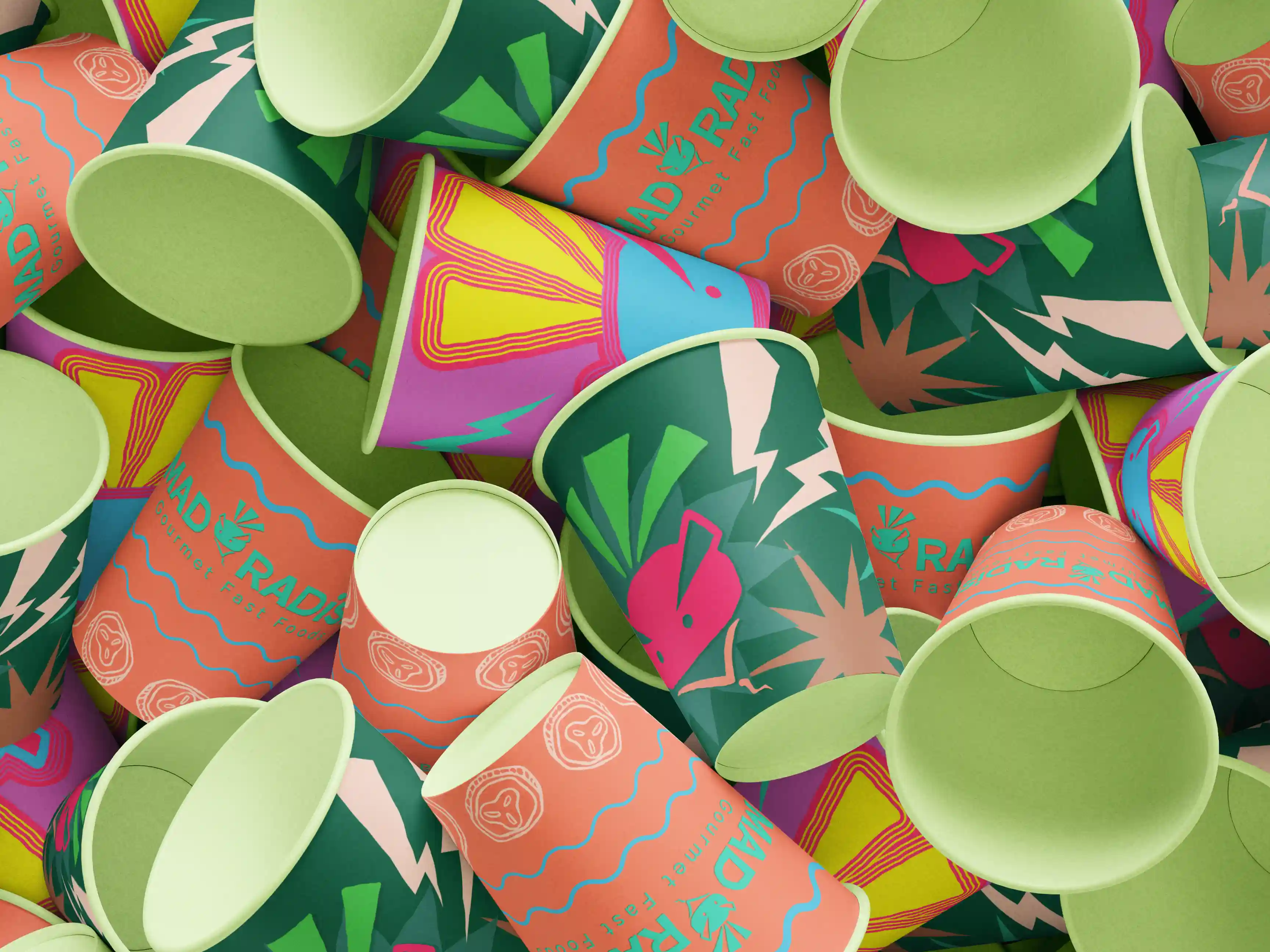 Mockup of a pile of three different rebranded Mad Radish coffee cup designs.