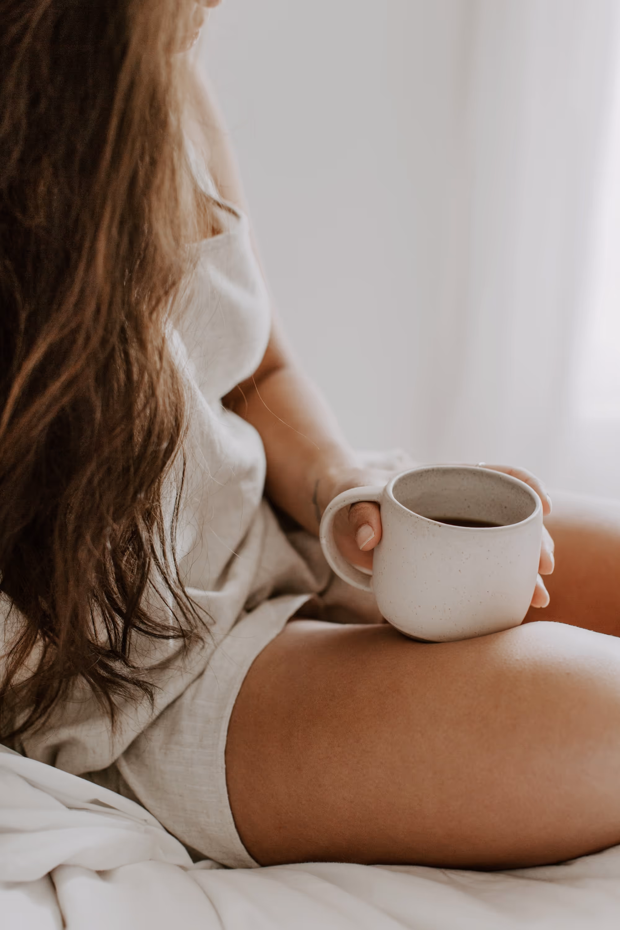 Woman in PJs holding coffee mug