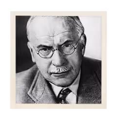Black and white portrait of an older man with glasses, mustache, and a suit looking directly at the camera.