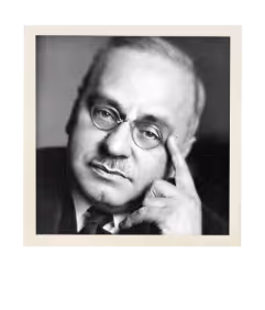 Black and white portrait of a middle-aged man with glasses resting his head on his hand.