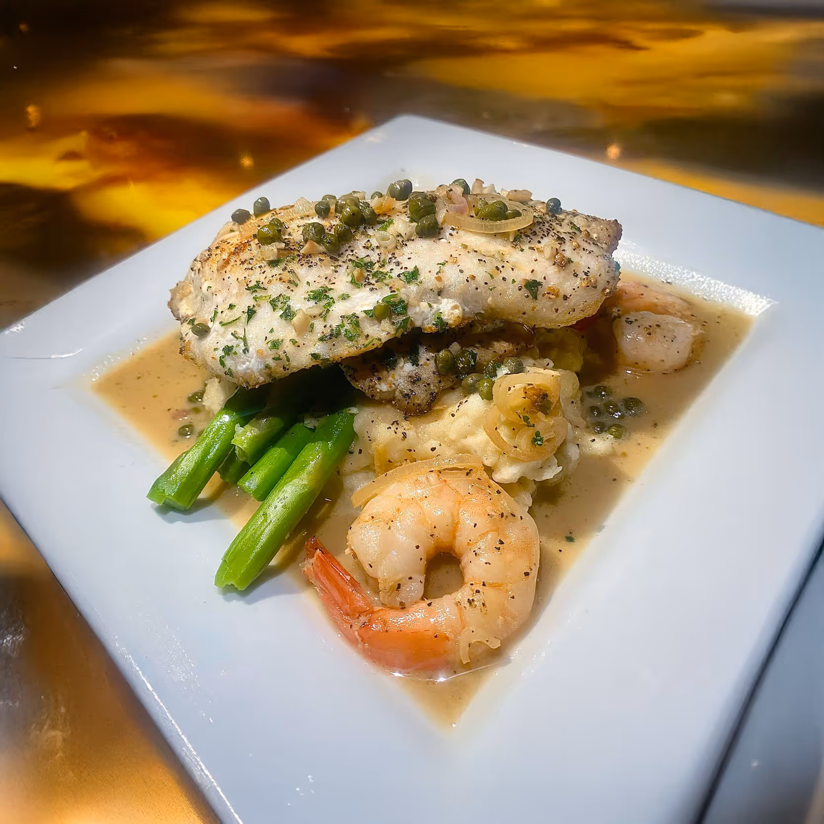Pan-Seared Grouper Special, served over mashed potatoes and asparagus with a rich shrimp piccata sauce.