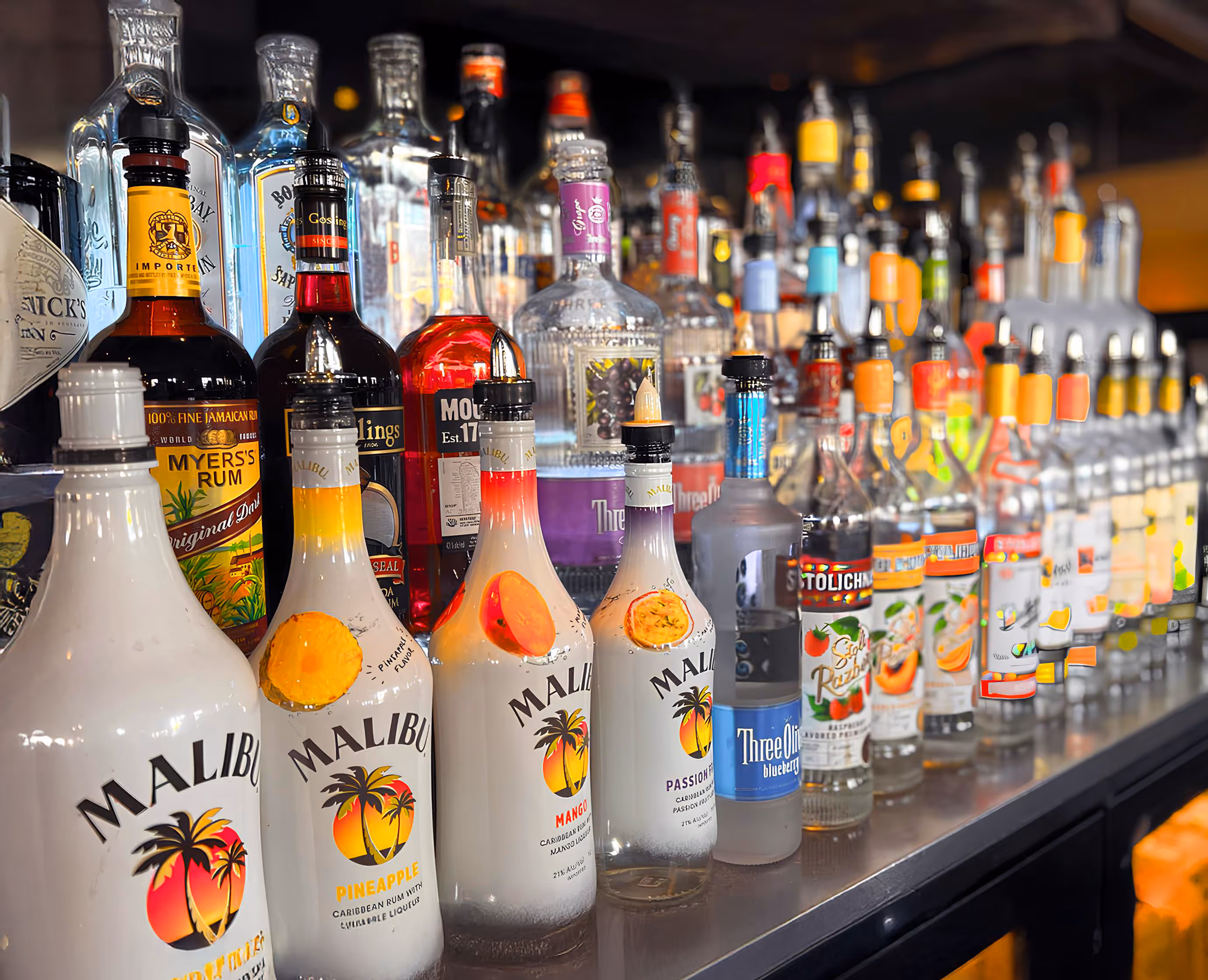 A selection of liquor bottles on a bar shelf.