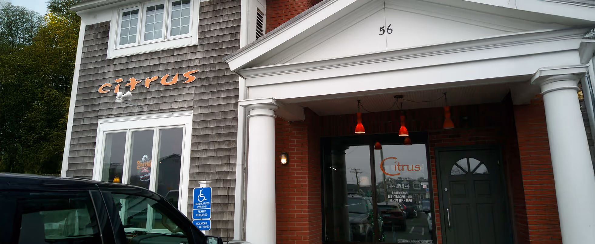 Two-story building with gray siding and white columns. "Citrus" is written in orange on the facade.