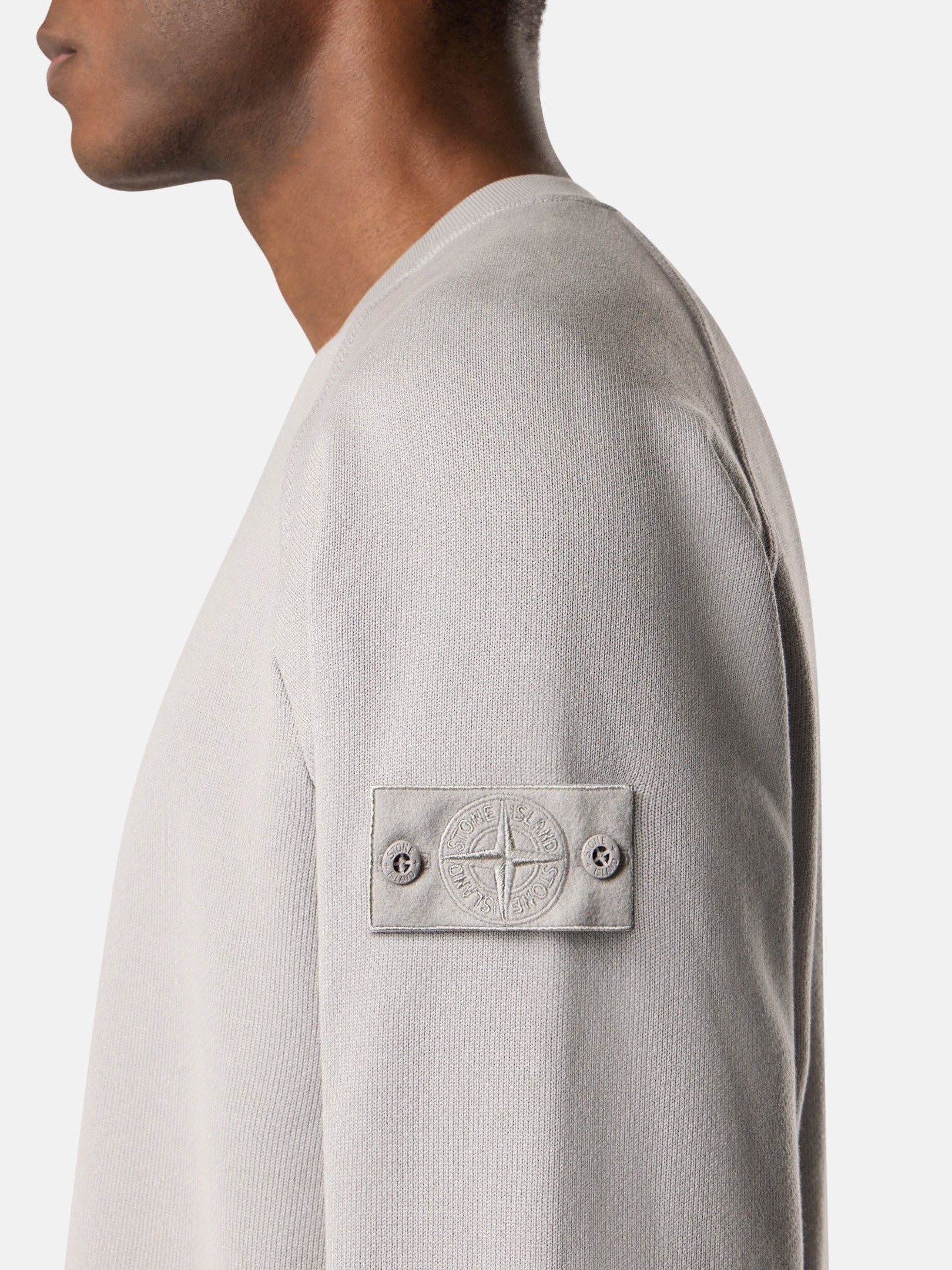 Caption: The badge remained. Only its contrast disappeared. Image Credit: Stone Island Ghost Pieces, monochrome compass badge across brushed cotton, David-TC, knitwear and Alcantara constructions. Courtesy Stone Island.