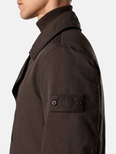 Caption: The badge remained. Only its contrast disappeared. Image Credit: Stone Island Ghost Pieces, monochrome compass badge across brushed cotton, David-TC, knitwear and Alcantara constructions. Courtesy Stone Island.
