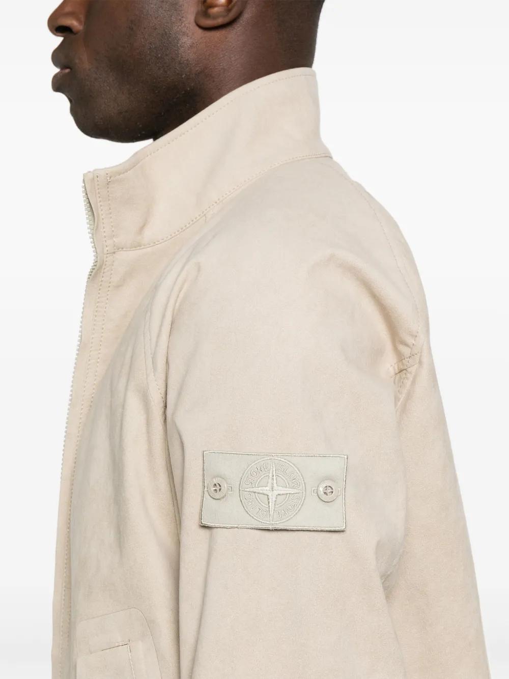 Caption: The badge remained. Only its contrast disappeared. Image Credit: Stone Island Ghost Pieces, monochrome compass badge across brushed cotton, David-TC, knitwear and Alcantara constructions. Courtesy Stone Island.