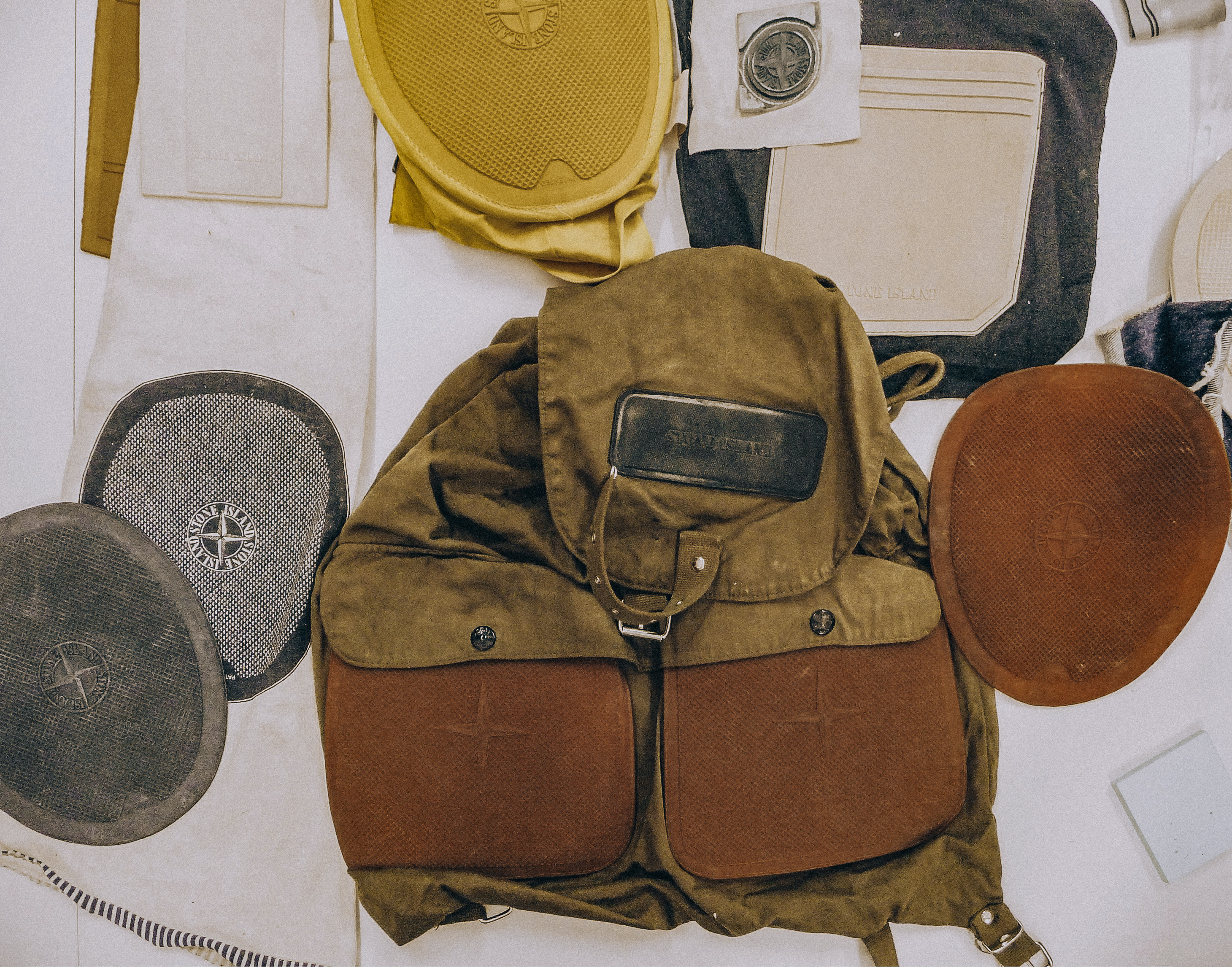 One element begins to separate from the working field: the rubber oval, already available at different scales. Image Credit: Stone Island backpack with rubber components and material studies. Courtesy of Massimo Osti Archive.
