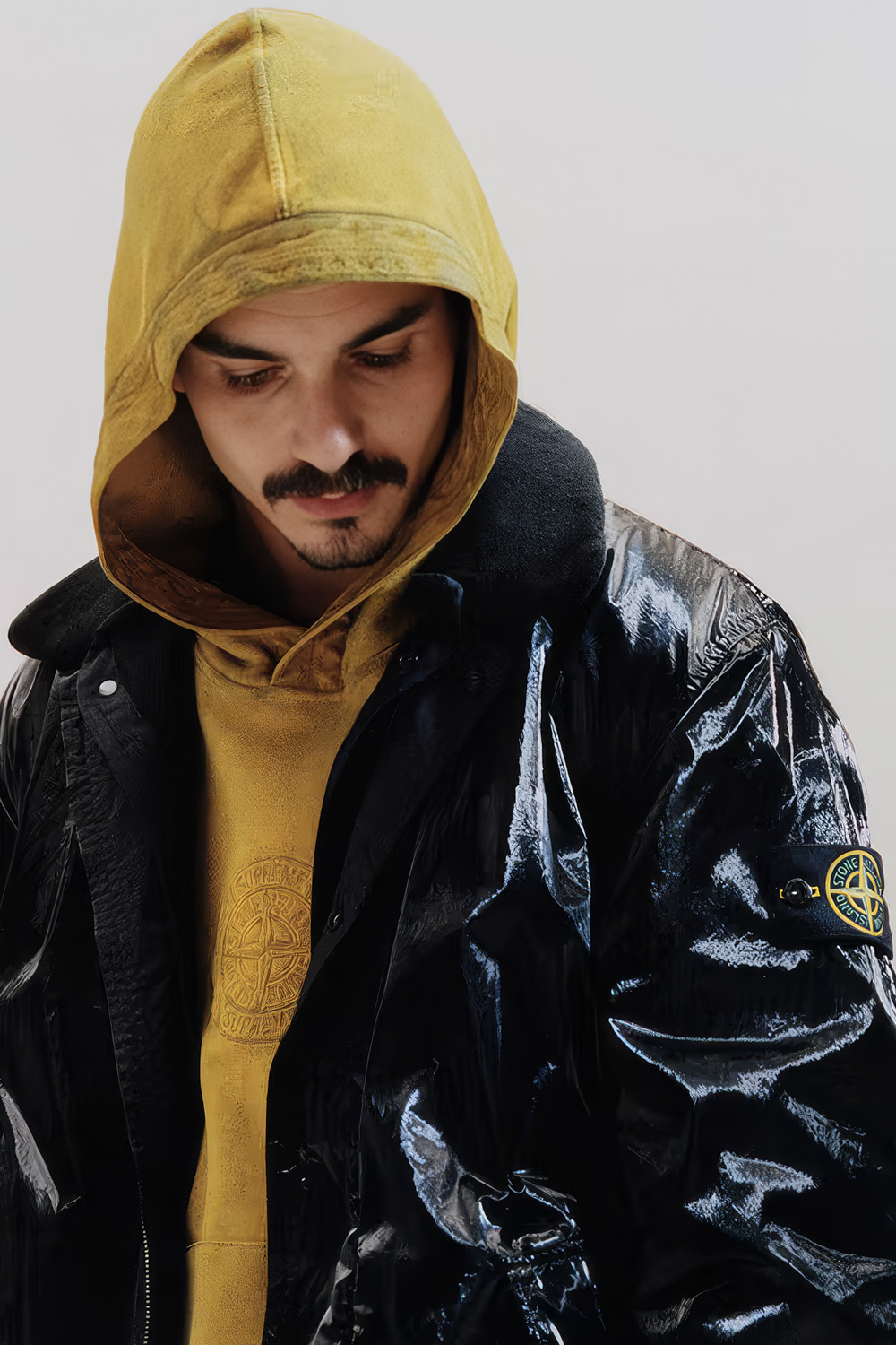 The collaboration preserves a readable chain of references while relocating them into a new system of signs. Image Credit: Supreme / Stone Island, Spring/Summer 2019 lookbook.