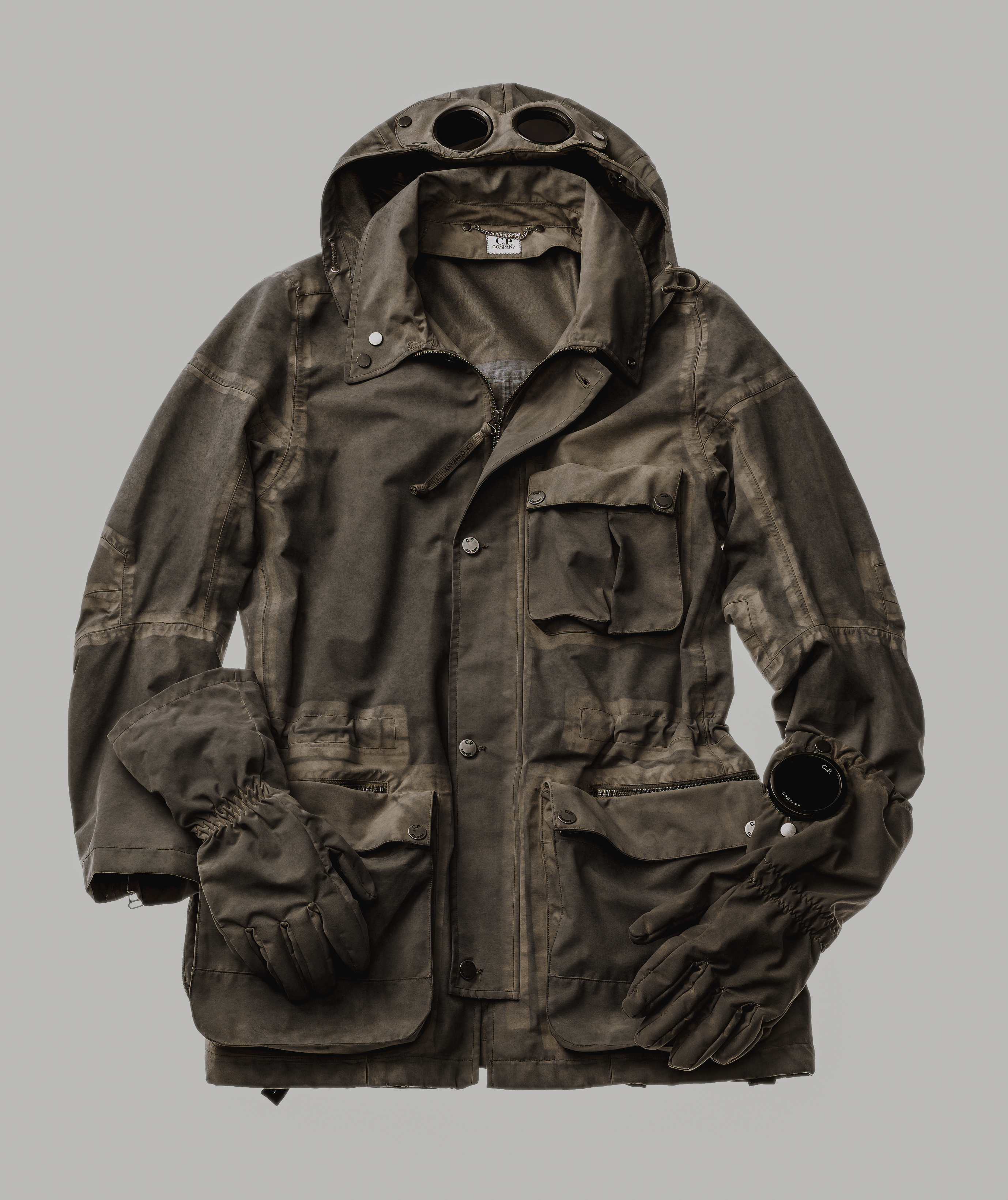 The finished object gathers every technical sign, while the driving premise that generated them remains invisible. Image Credit: C.P. Company, 1000M Goggle Jacket, Autumn/Winter 2009–10. Designed by Aitor Throup.