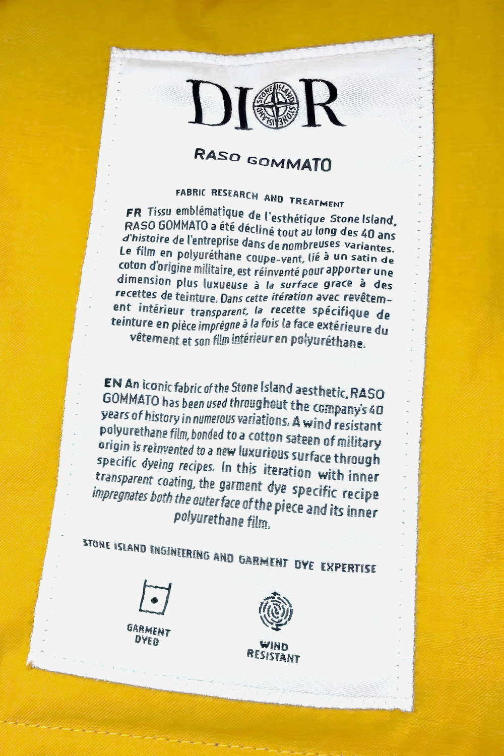 The collaboration’s deepest inheritance is documentary: Stone Island’s technical language crosses almost intact into a Dior label, where one edited clause and one new sentence distinguish a collaborative document from its predecessor.