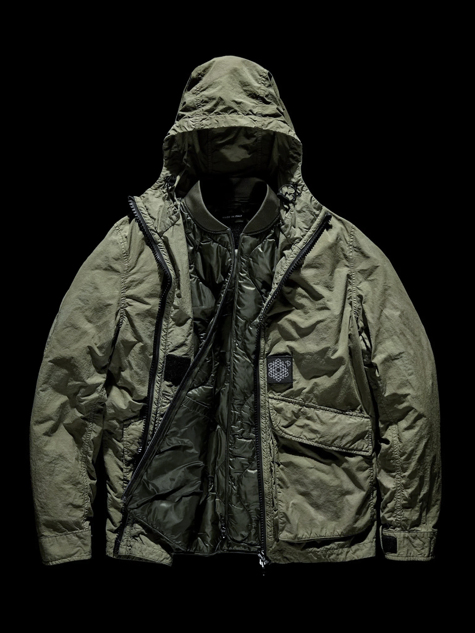 A numbered position becomes a garment: the jacket Fabio wore through Dia. Image Credit: Plurimus NO_S27, Reversible Stealth Camo Jacket + Inner Jacket.