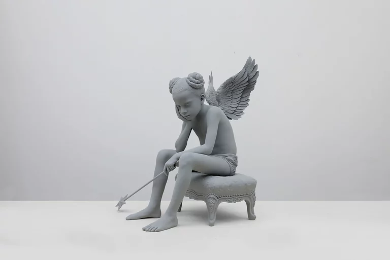 Remove the room and the constant becomes clear: the same body, chair, wings, and fallen arrow await another setting. Image Credit: Hans Op de Beeck, Zhai-Liza (angel), 2024. Photo: Dominique Provost.