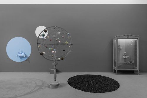 Scale shifts: a still life opens another space, an orrery models a universe, and a cabinet contains a world small enough to possess. Image Credit: Hans Op de Beeck, Vanishing Point, 2026. Photo: Hugard & Vanoverschelde.