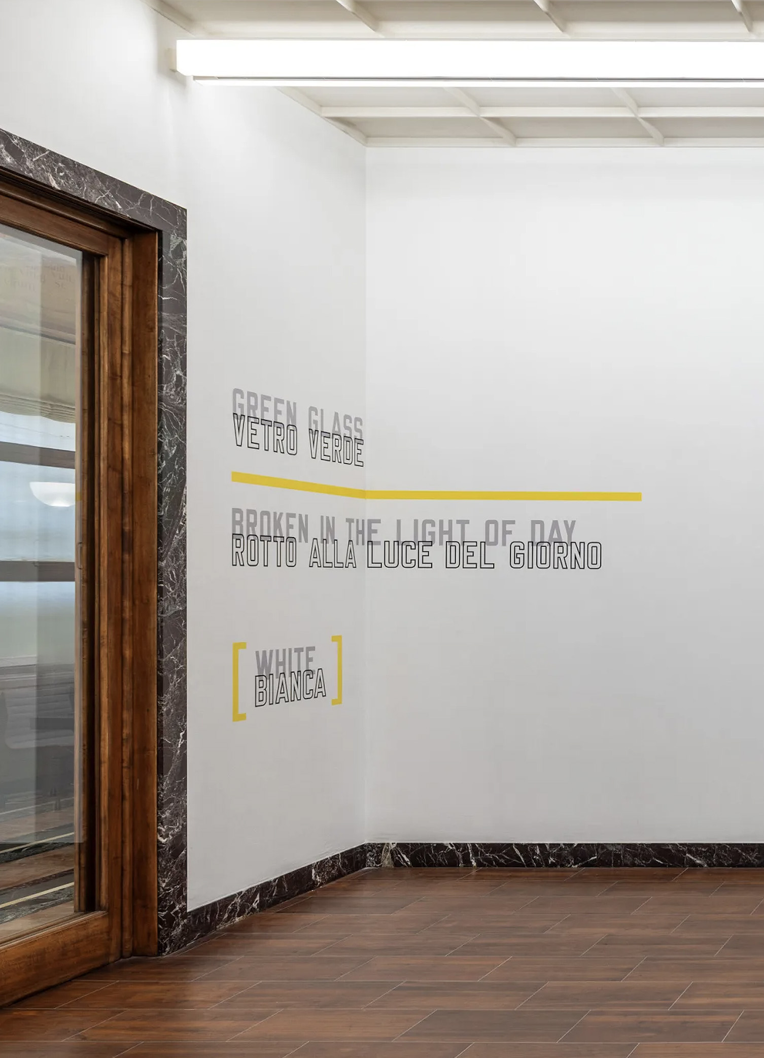 In GREEN GLASS, the rule separates the glass from its breaking, while yellow is carried by the rule and brackets rather than by the colour words. Image Credit: Installation view (detail). Courtesy of the Artist and MASSIMODECARLO. Photo: Roberto Marossi.
