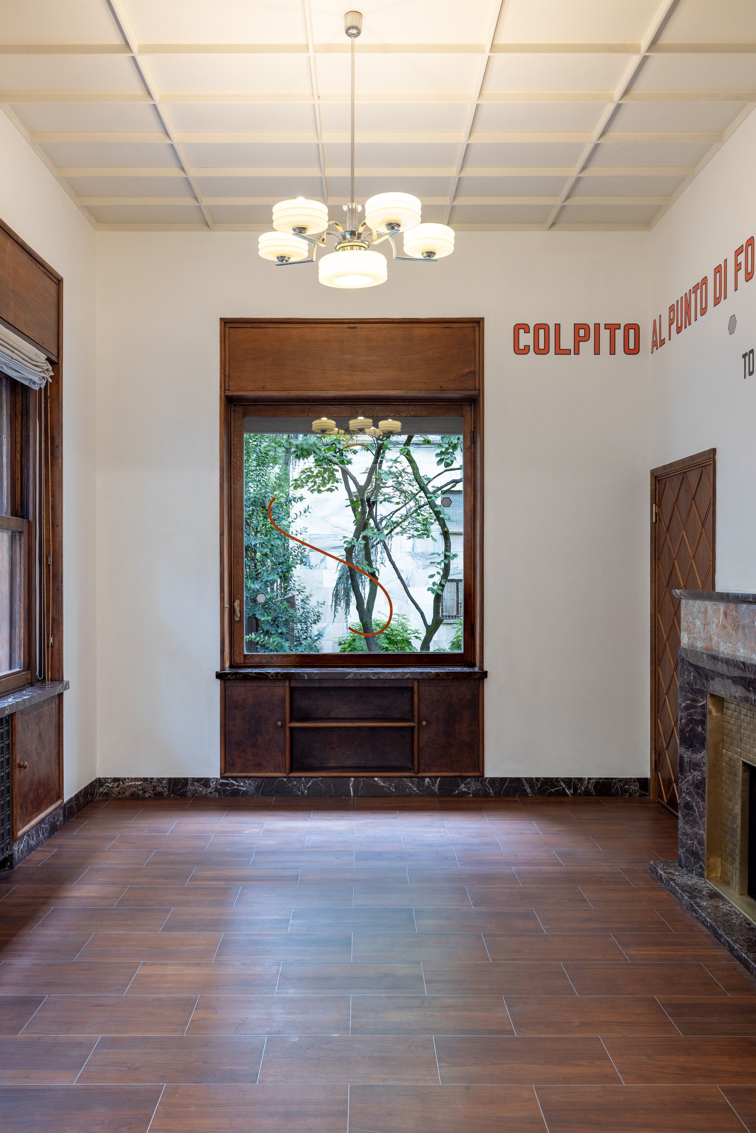 On the adjacent window, the curve and hexagons recur without accompanying words. Image Credit: Installation view. Courtesy of the Artist and MASSIMODECARLO. Photo: Roberto Marossi.