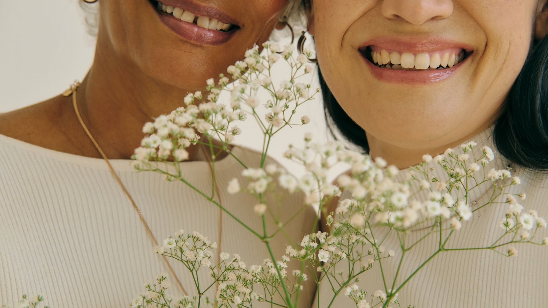 Image of a halved blood orange against baby's breath flowers and a soft background, representing female fertility.