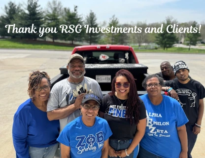 Group of seven diverse adults smiling outdoors in front of a pickup truck with text thanking RSG Investments and clients.
