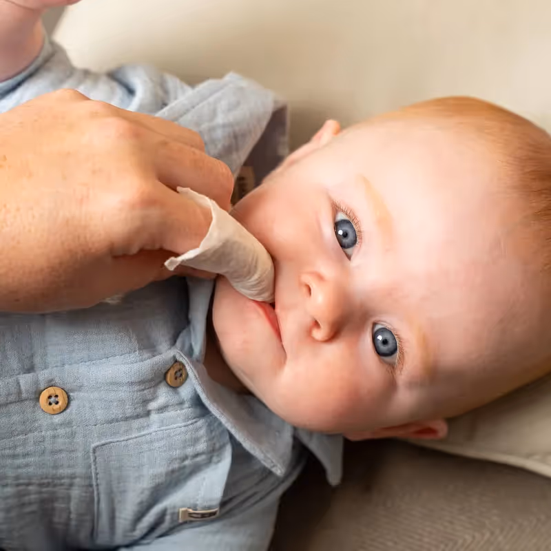 A baby with a weaning toy