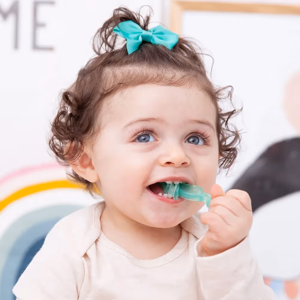 Young toddler with chewable toothbrush