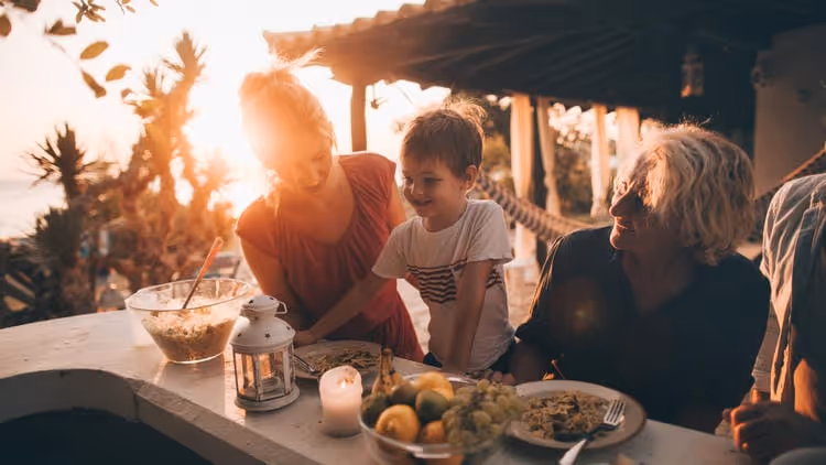 A young child having a meal with it's parents
