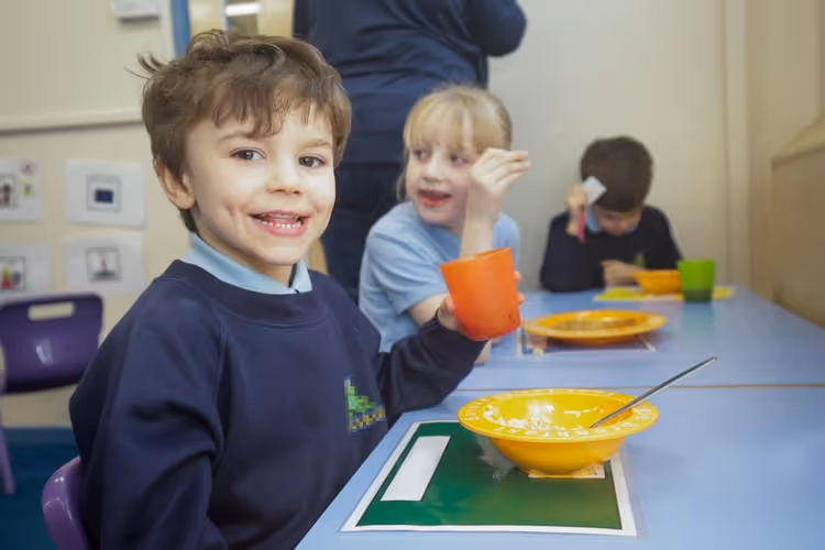 A child from the magic breakfast charity campaign enjoying a full breakfast