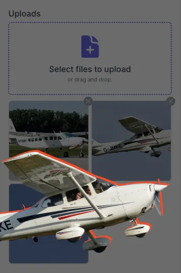 Small white propeller airplane with blue and red stripes in flight against a gray background.