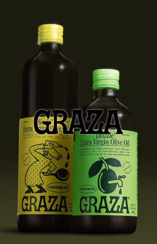 Two dark bottles of Graza brand olive oil with bright yellow and green labels for cooking and finishing oil.