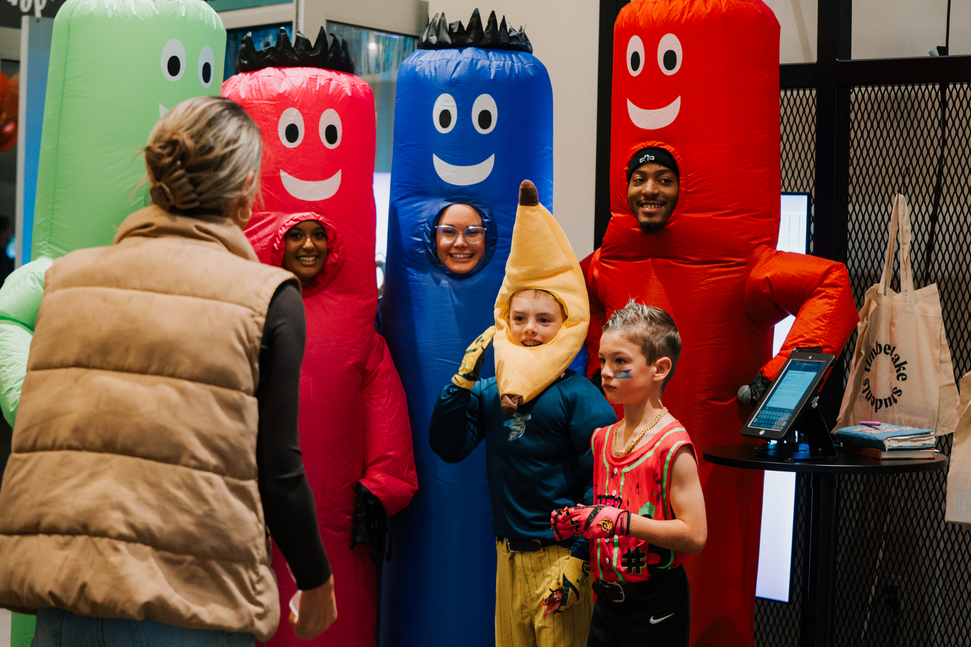 Student leaders in an inflatable costume greeting students and families.