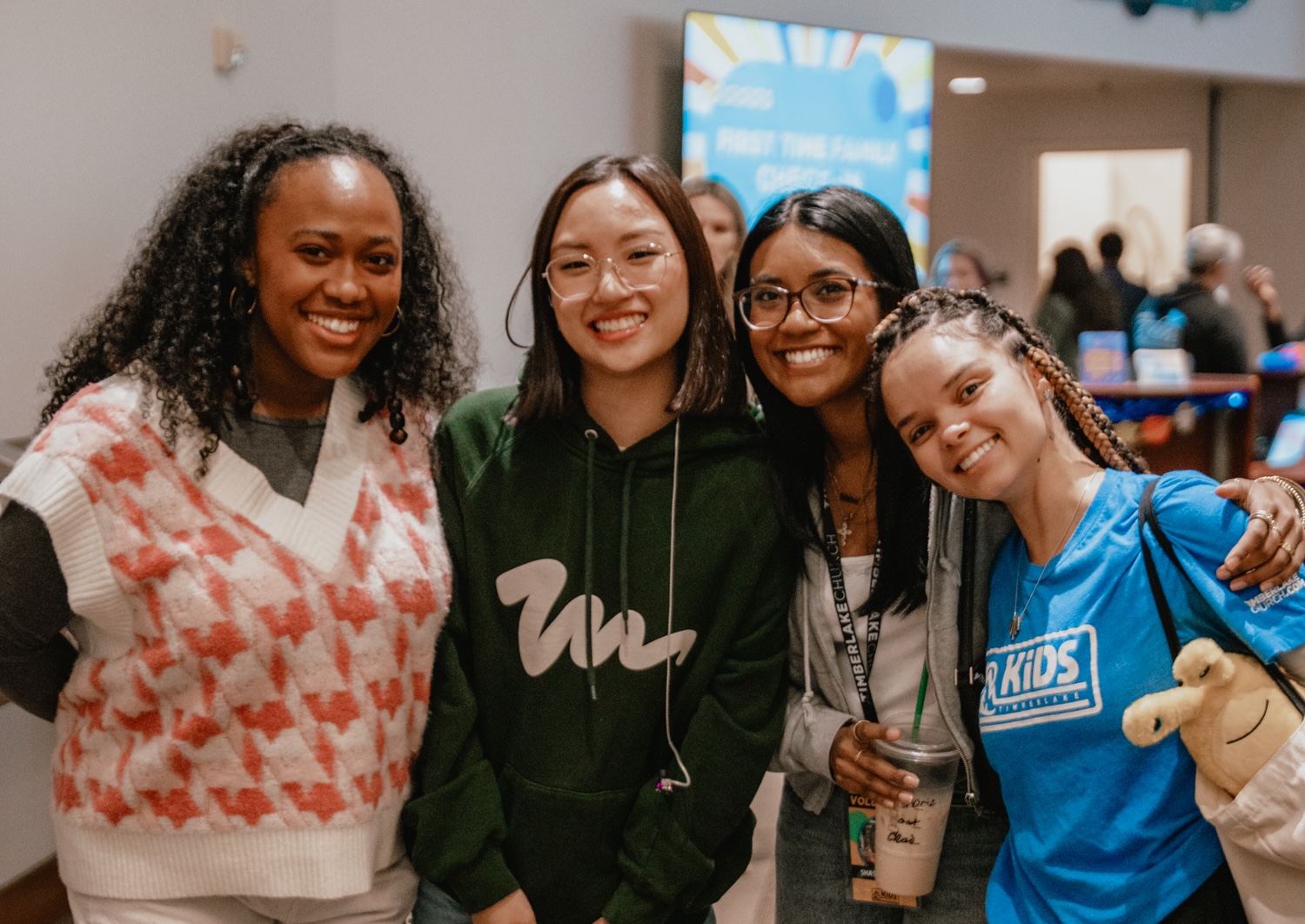 Four ladies smiling together at the camera.