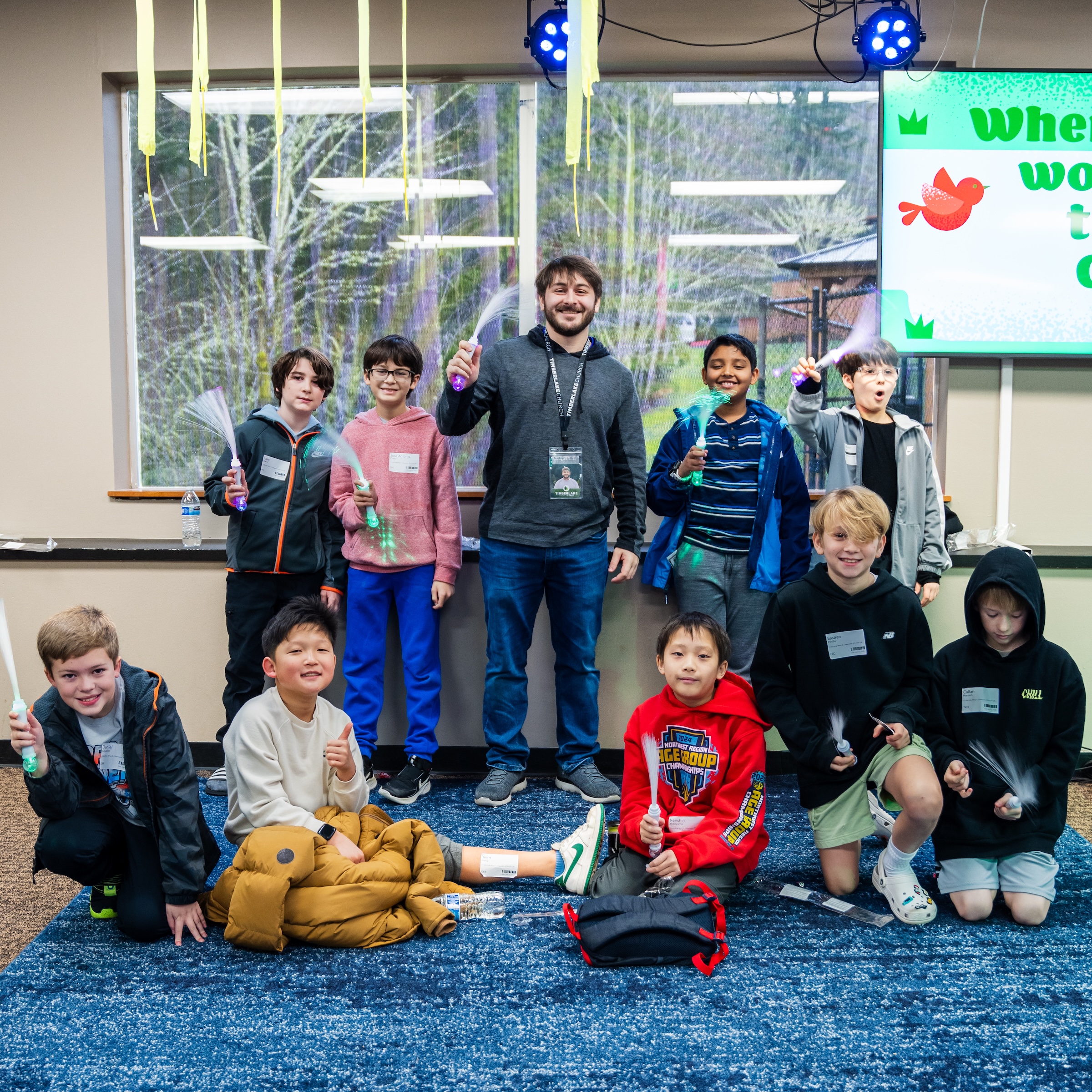A group of young boys posing for a photo with their Timberlake leader.