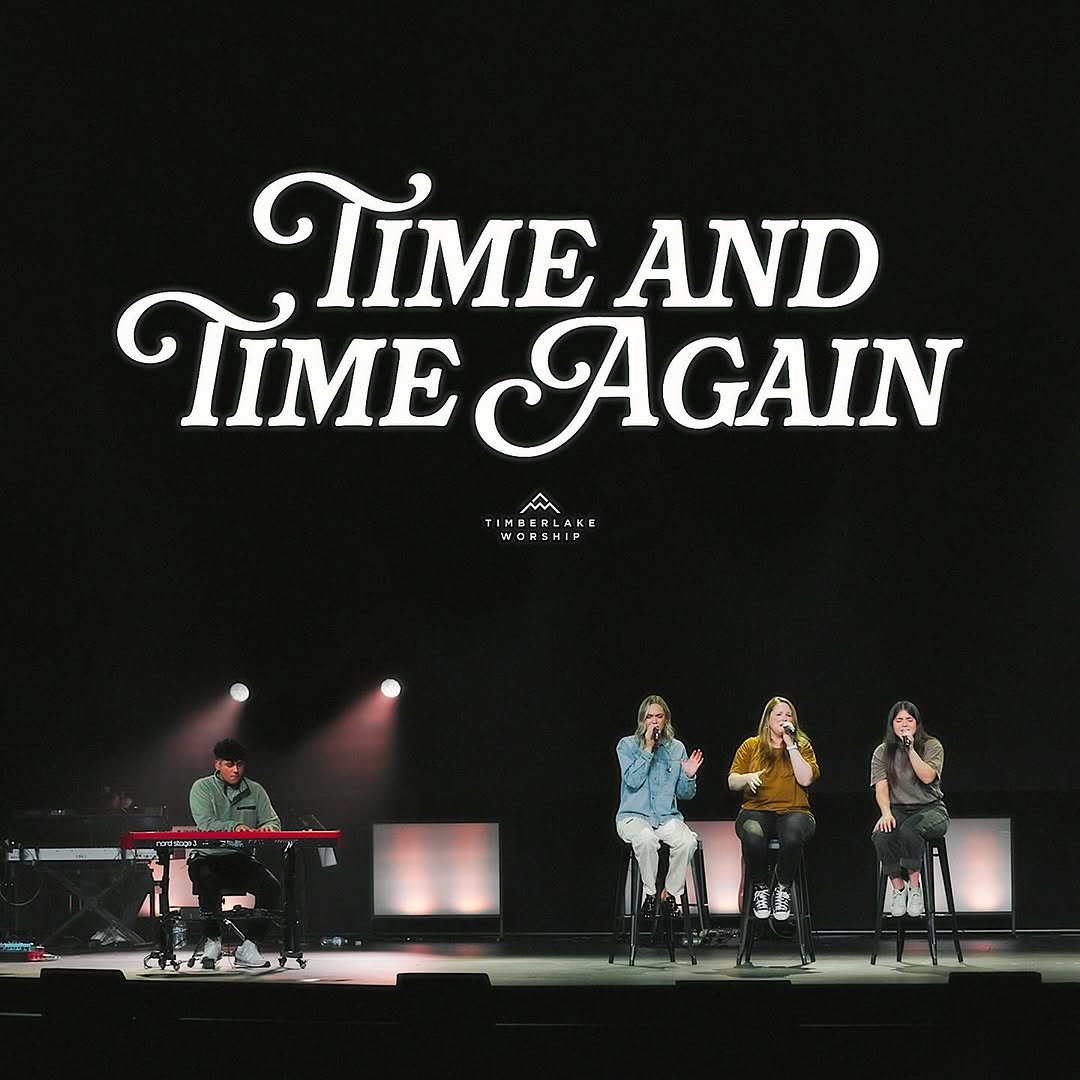 A dark black background song cover of a piano player on stage with three singers sitting together.