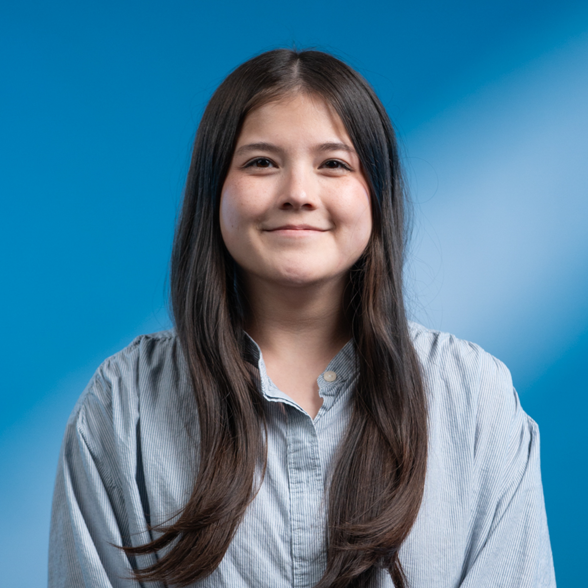 A young woman with long brown hair and brown eyes.