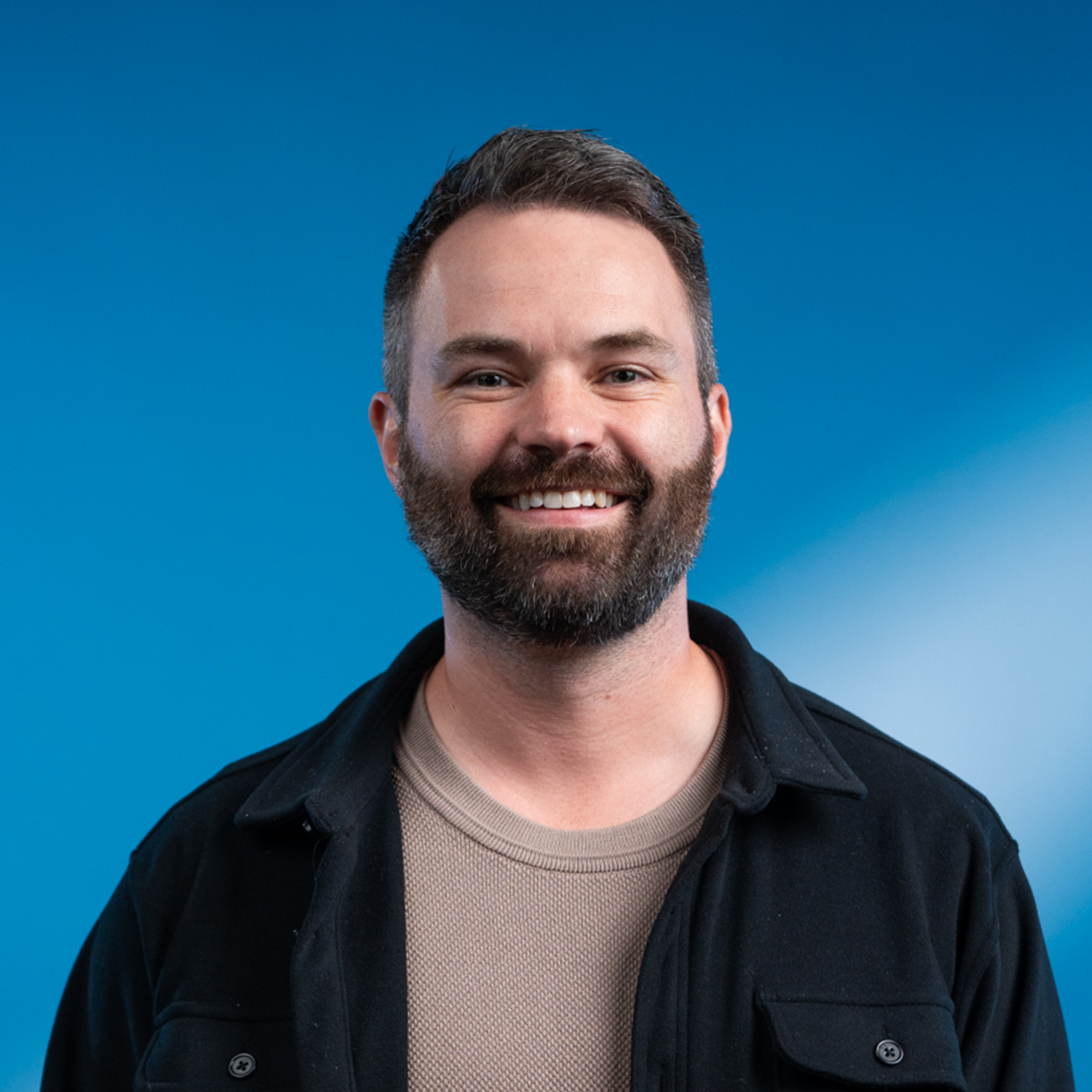 A middle-aged white man with a brown hair and a beard.