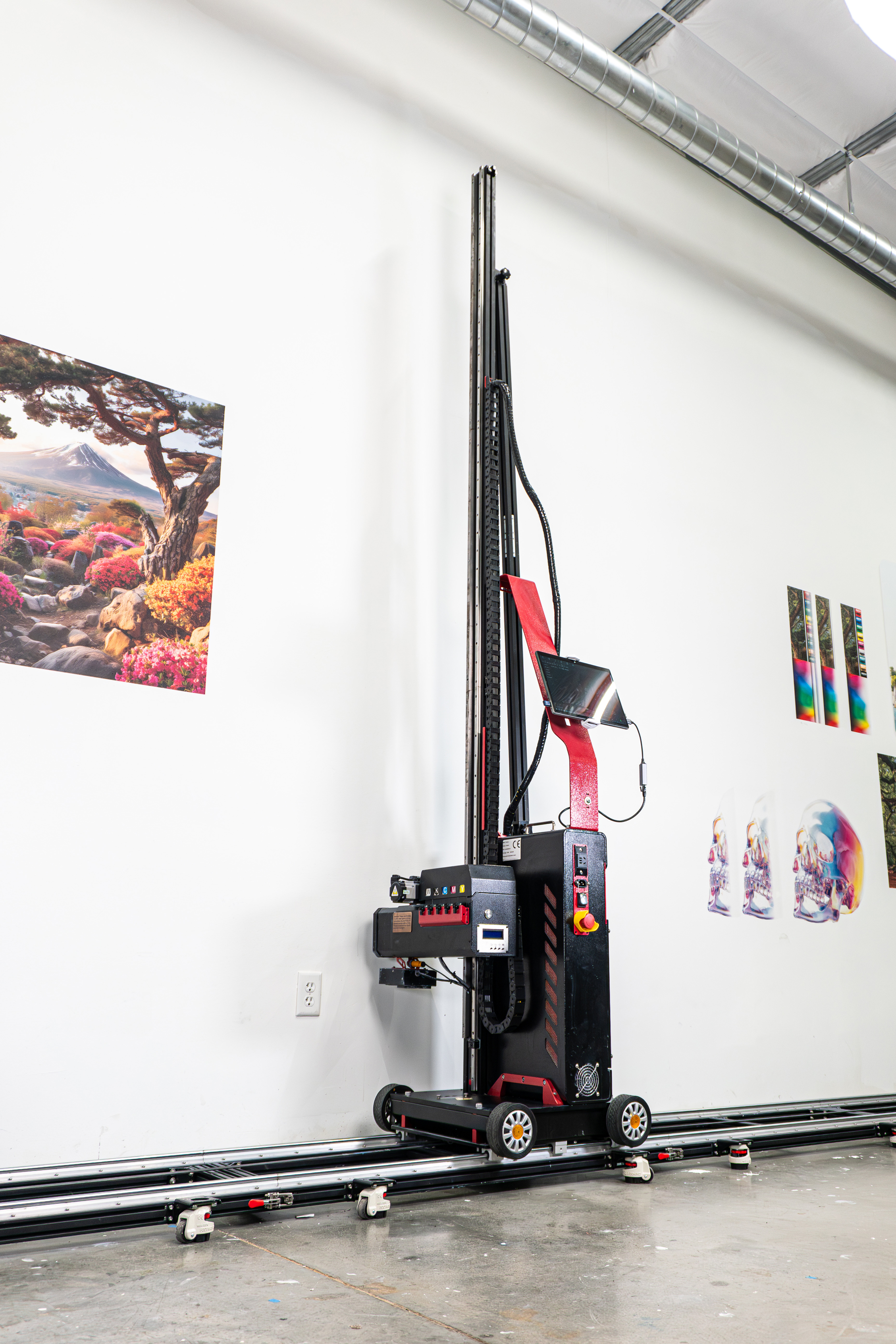 WallPen robotic painting machine with pink light trails in a dark room.
