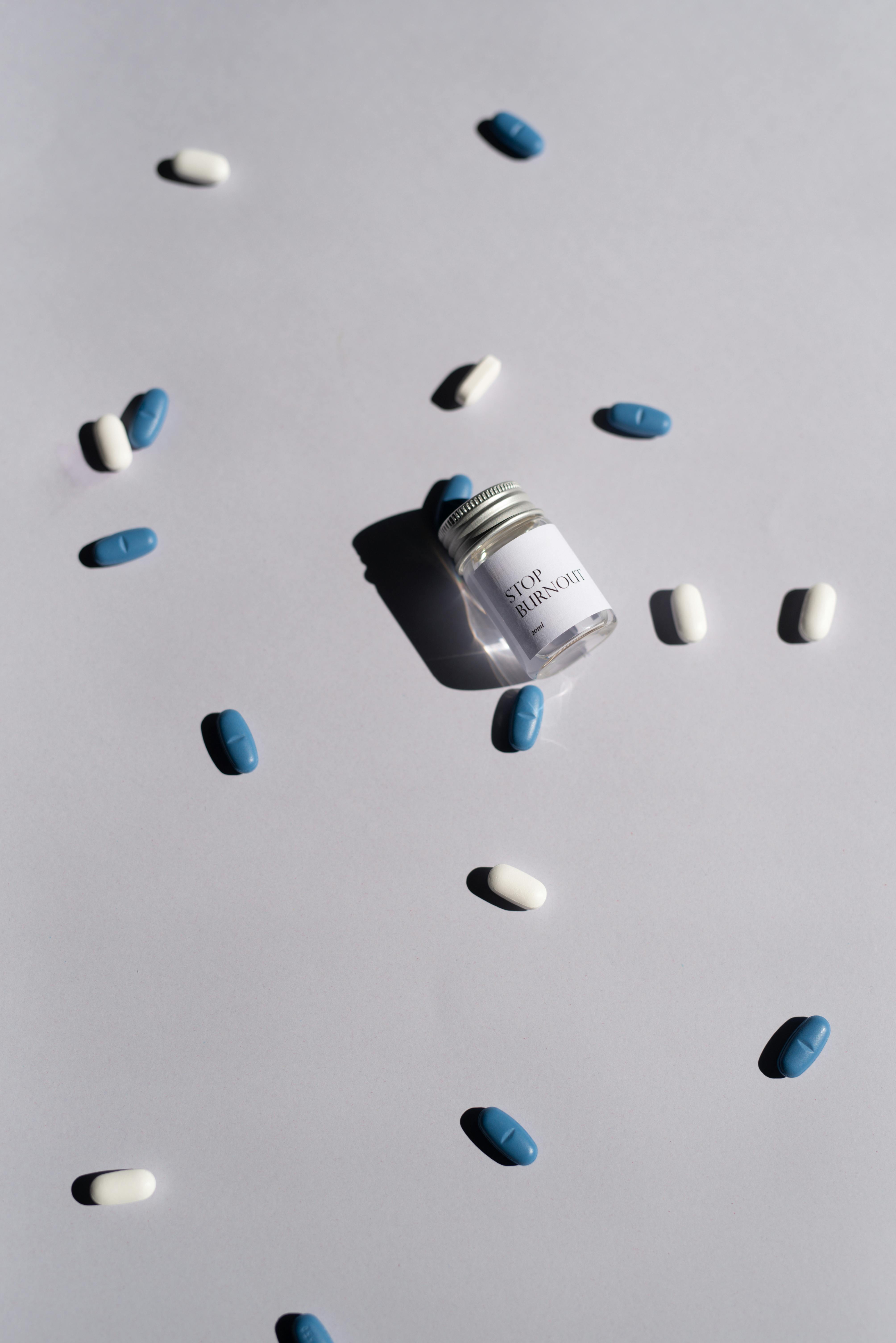 Editorial flat lay of capsules and a medicine bottle