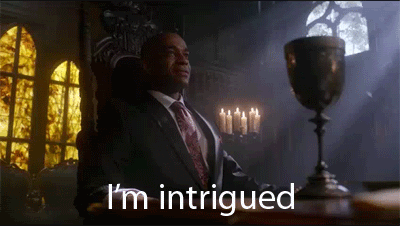 man sitting in chair saying I'm intrigued gif