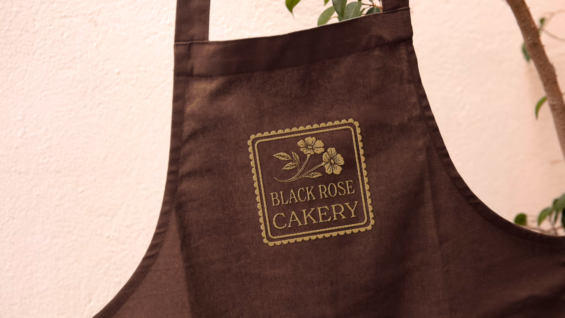 An apron with Black Rose Cakery logo.