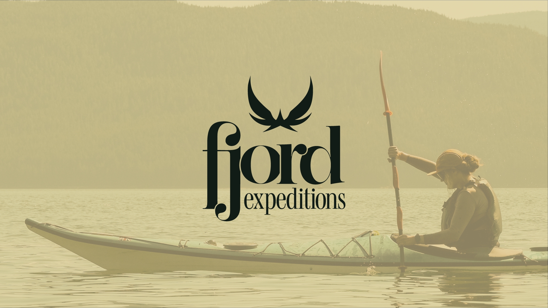 Person paddling a kayak on calm water with forested hills in the background and 'fjord expeditions' logo overlay.