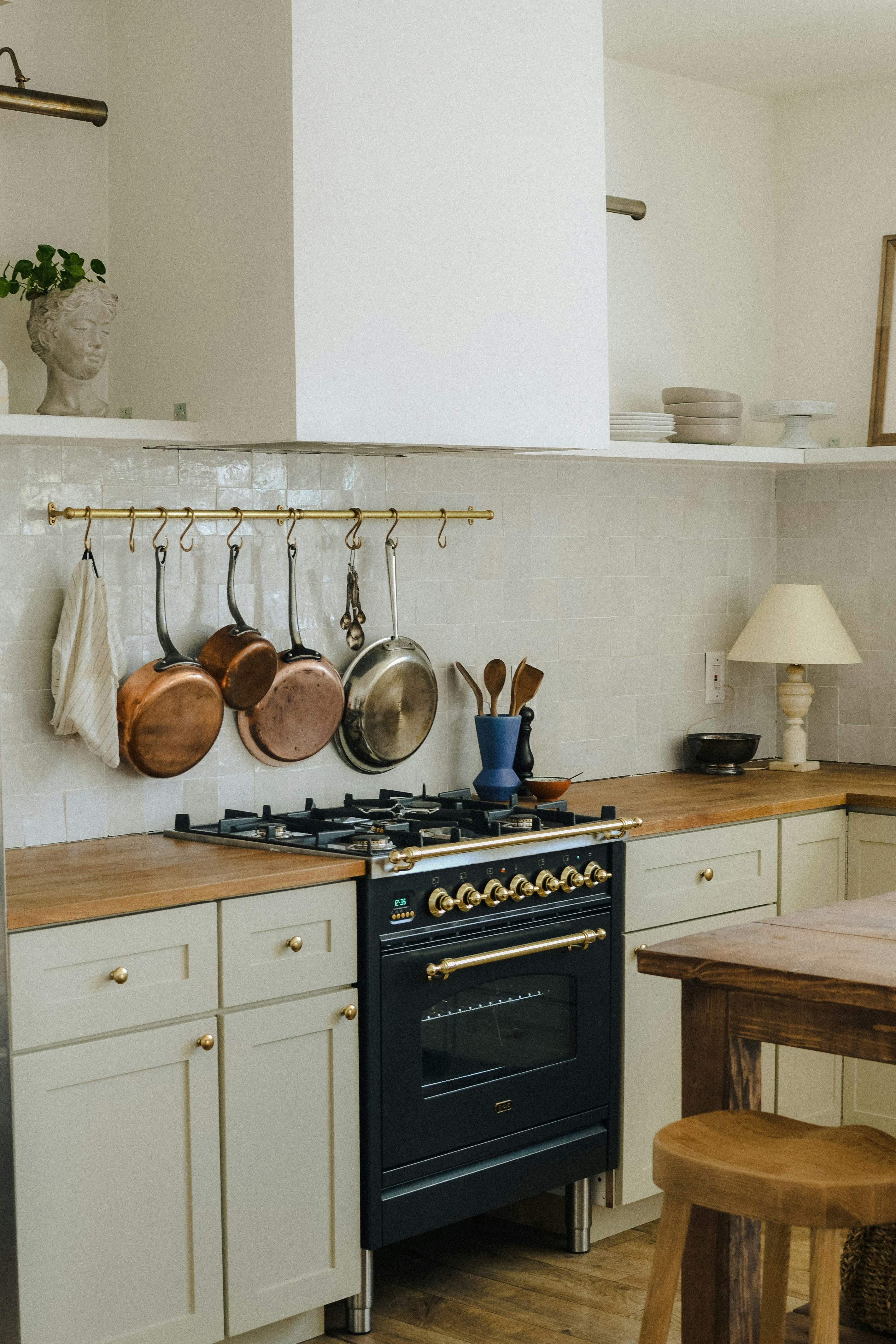 Copper pans above a black range