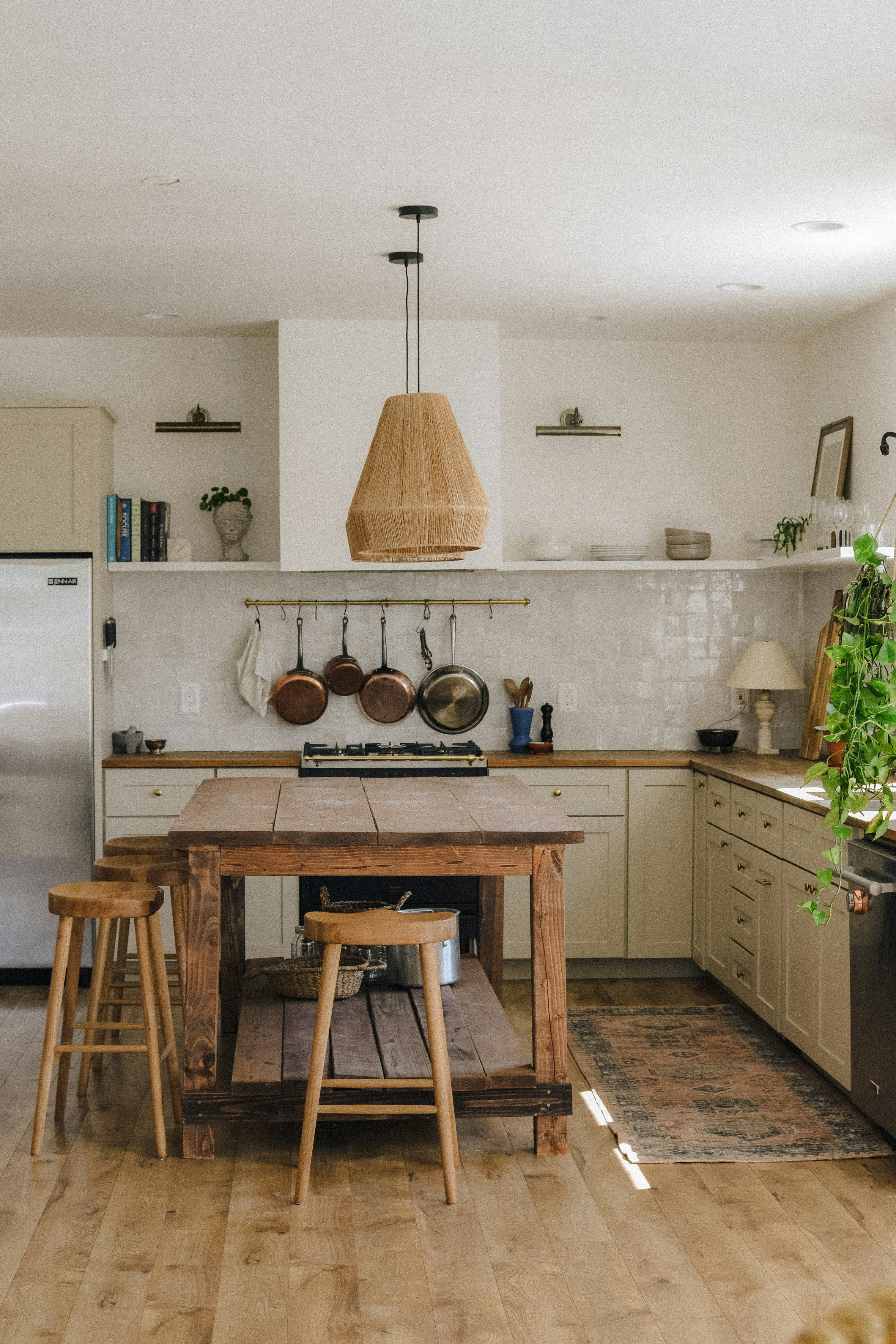 Rustic kitchen with a wood island and stools