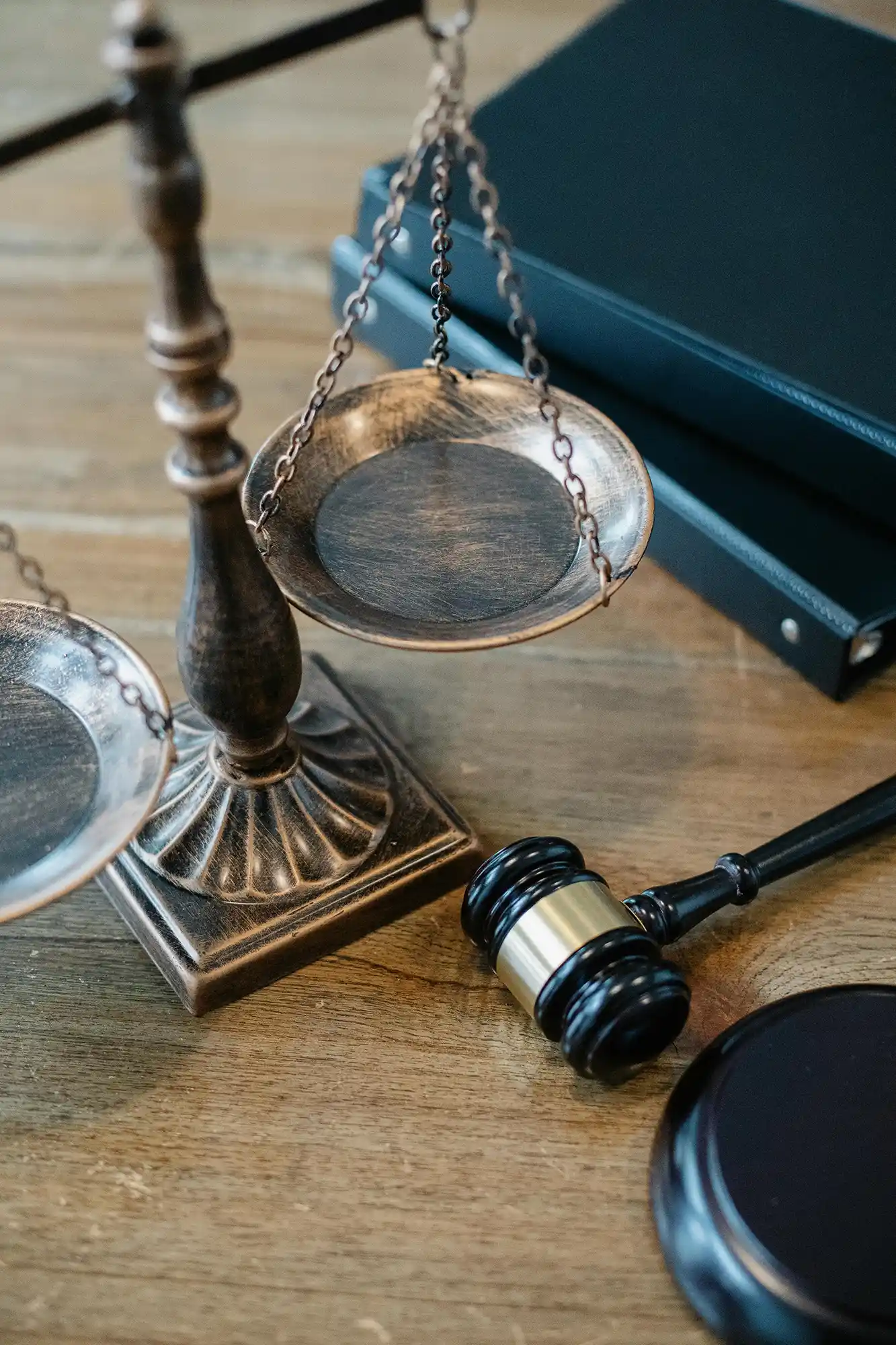 An overhead view of the scales of justice and a gavel on a desktop surface.