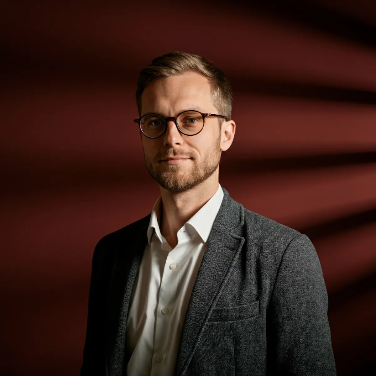 Professional portrait of an adult man facing the camera.