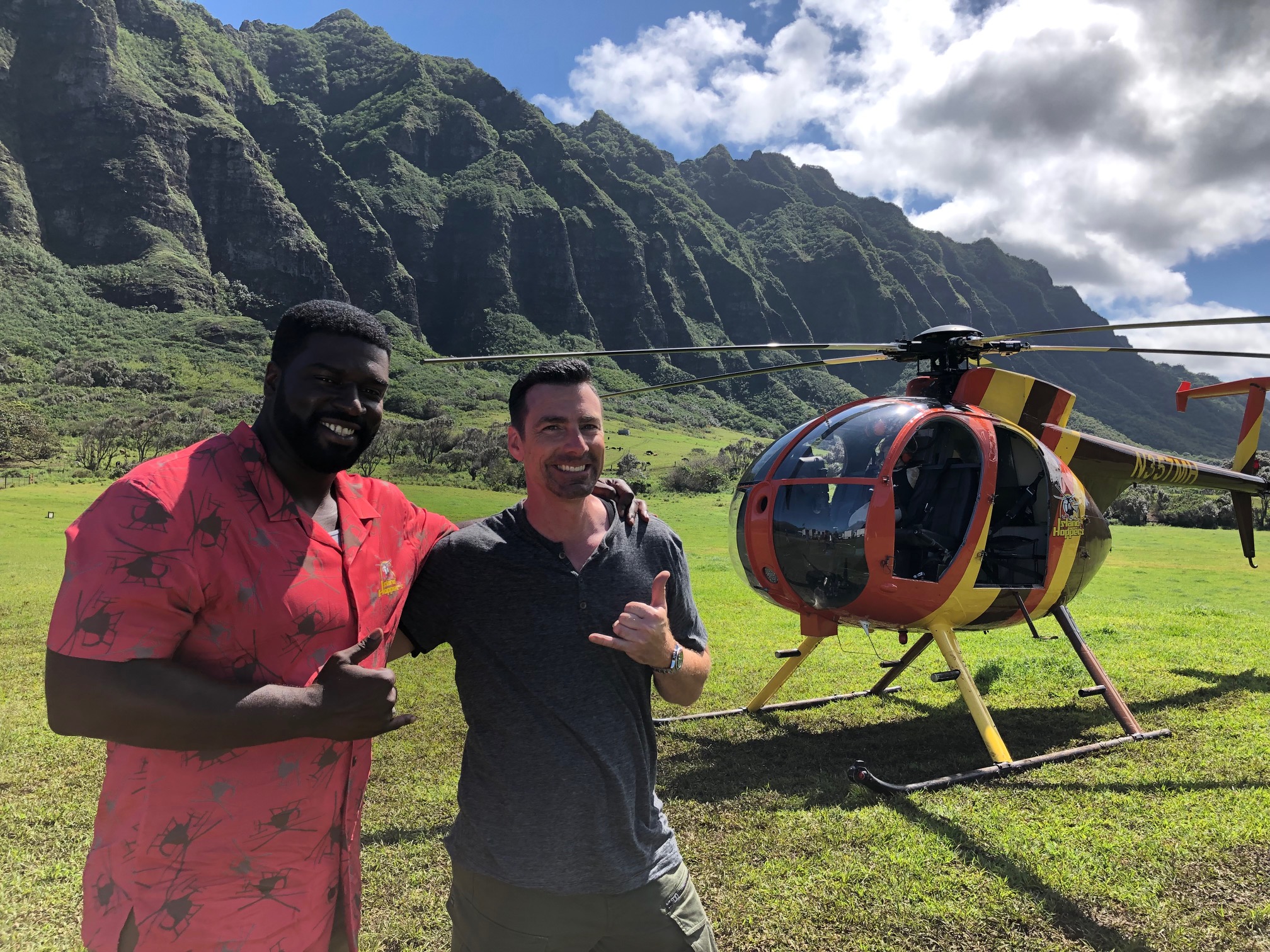 Doug and TC standing in front of Magnum PI helicopter before filming