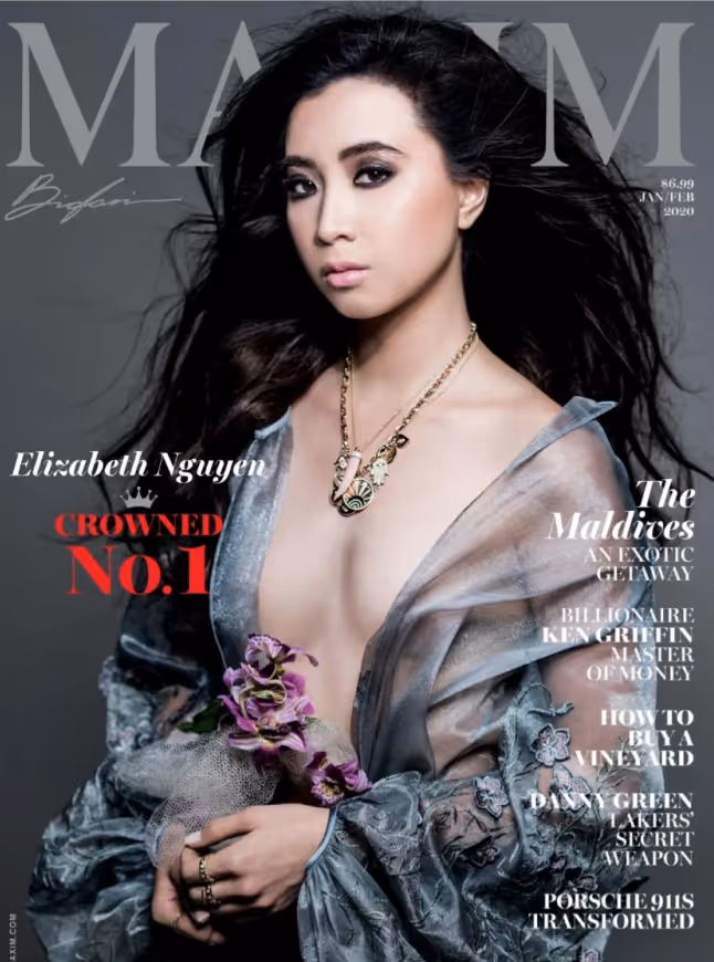 Elizabeth Nguyen with long dark hair wearing a sheer, deep V-neck dress holding purple flowers on the cover of Maxim magazine.